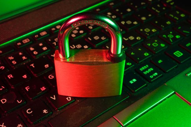 A photo of a padlock on a computer keyboard.