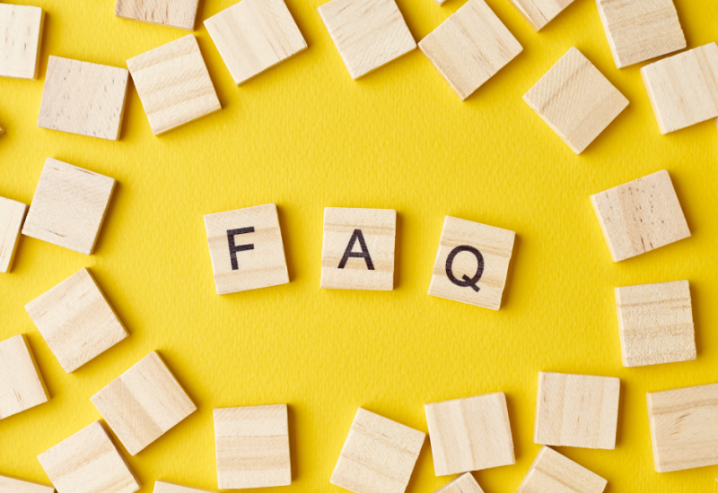 Wooden blocks with the abbreviation FAQ on a yellow background.