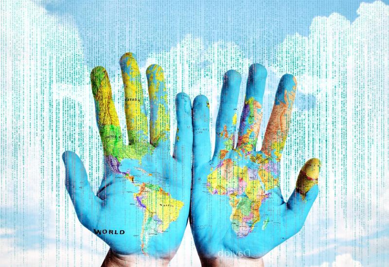Image of world map painted on hands held out. 